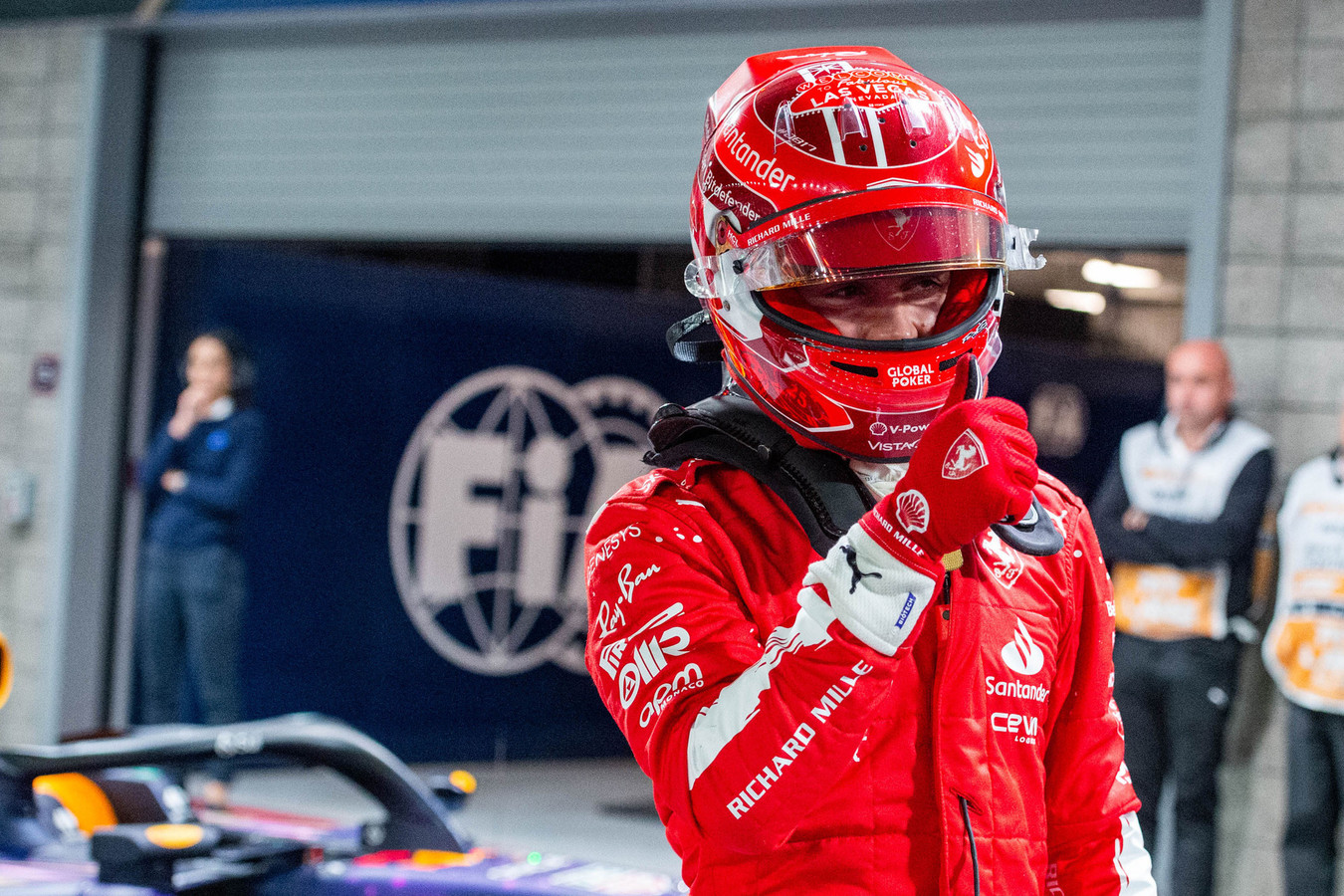 A driver in race suit in the garage